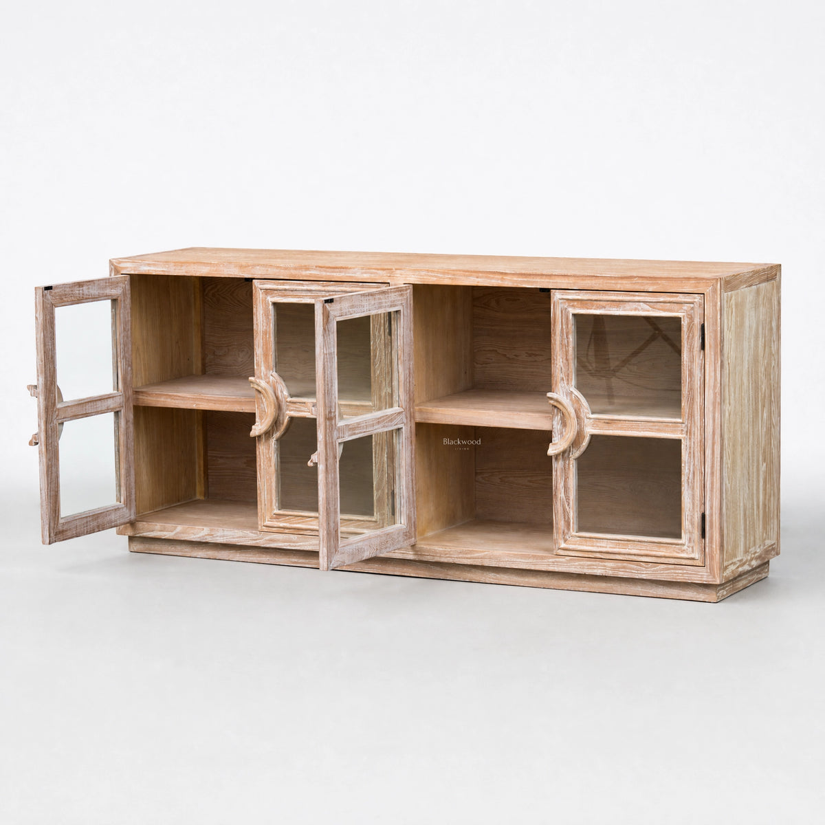 Wide elm sideboard with glass doors open to show interior shelves and a weathered coastal finish.
