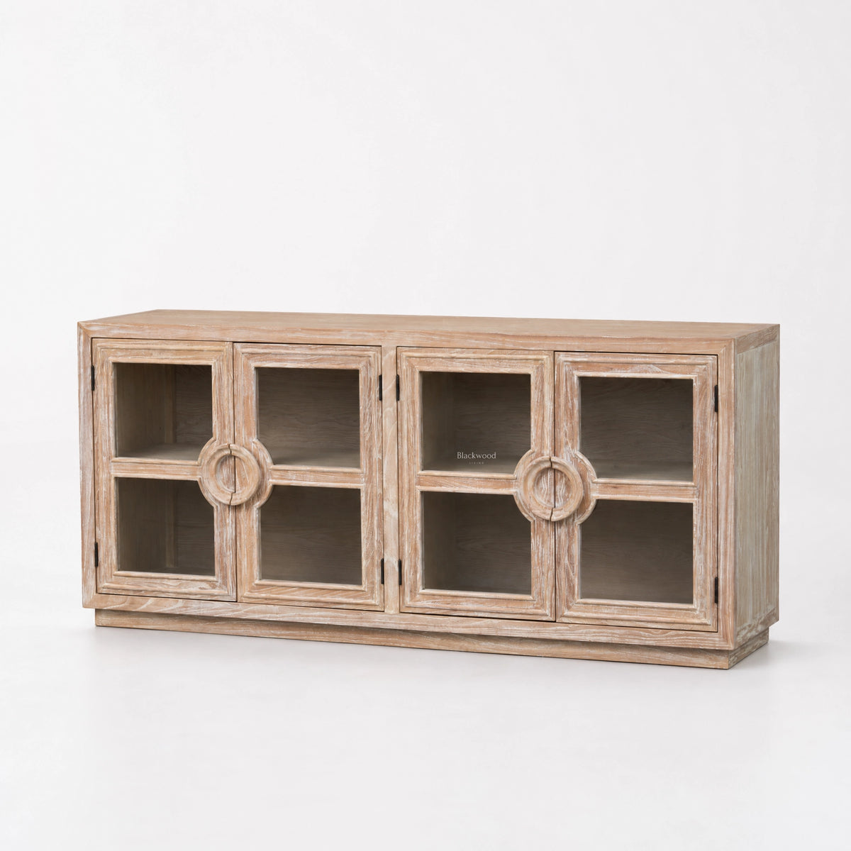 Light weathered elm sideboard with glass doors and carved circular handles, offering coastal-inspired storage in traditional timber.