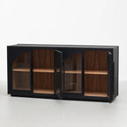 Dark elm sideboard with four glazed arched doors open to reveal warm walnut interior shelving and architectural ecclesiastical detailing.