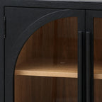 Dark elm sideboard door featuring a glazed arched panel, vertical handle, and warm wood interior shelf with ecclesiastical detailing.