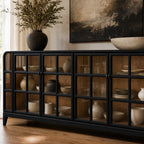 Black grid-pane sideboard with glazed doors displaying ceramic vases, combining heritage style with natural ash timber character.