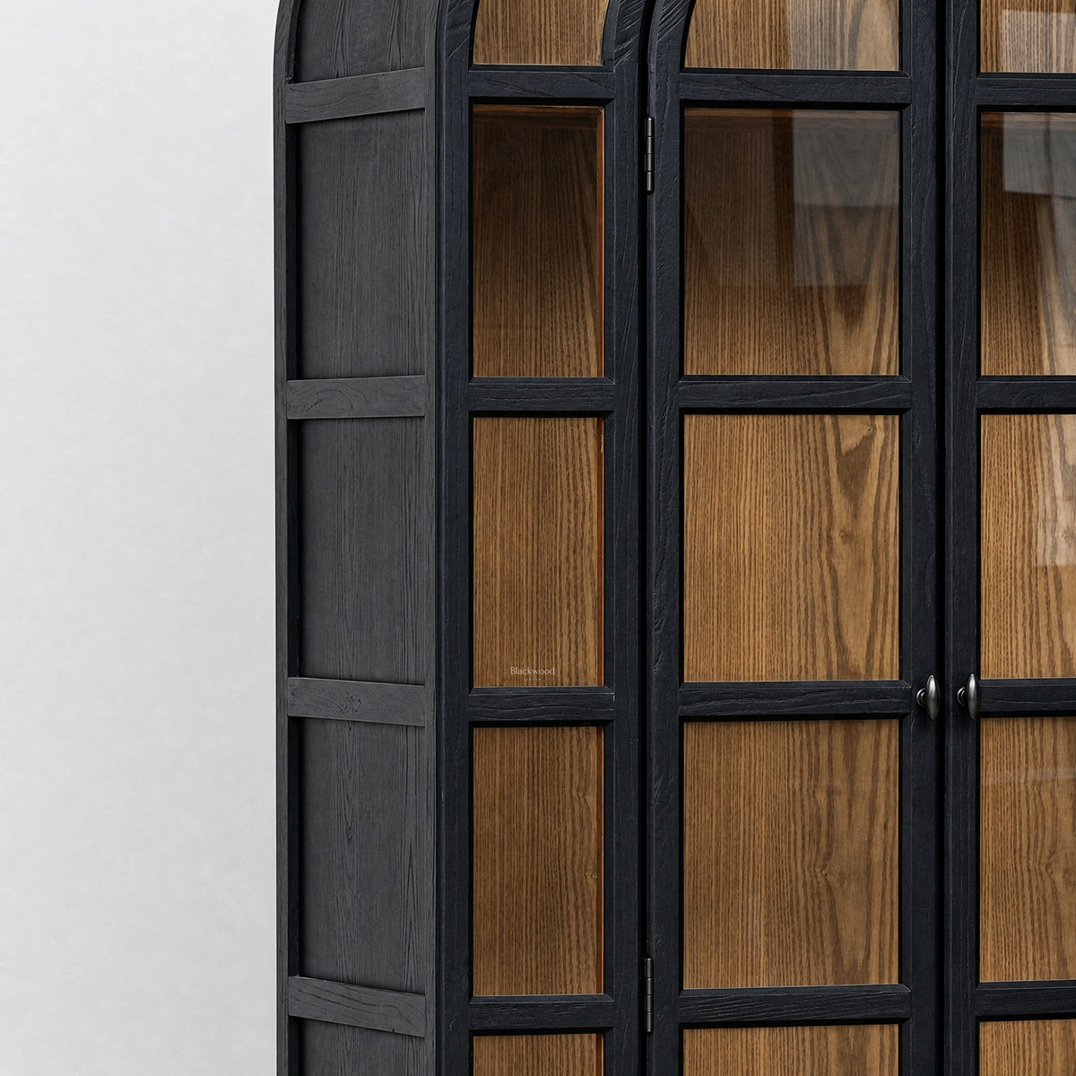 Dark finished elm cabinet with glazed arched doors showcasing warm natural wood grain and traditional heritage design.