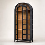 Tall black arched cabinet with glazed doors reveals warm natural elm wood interior and traditional heritage design.