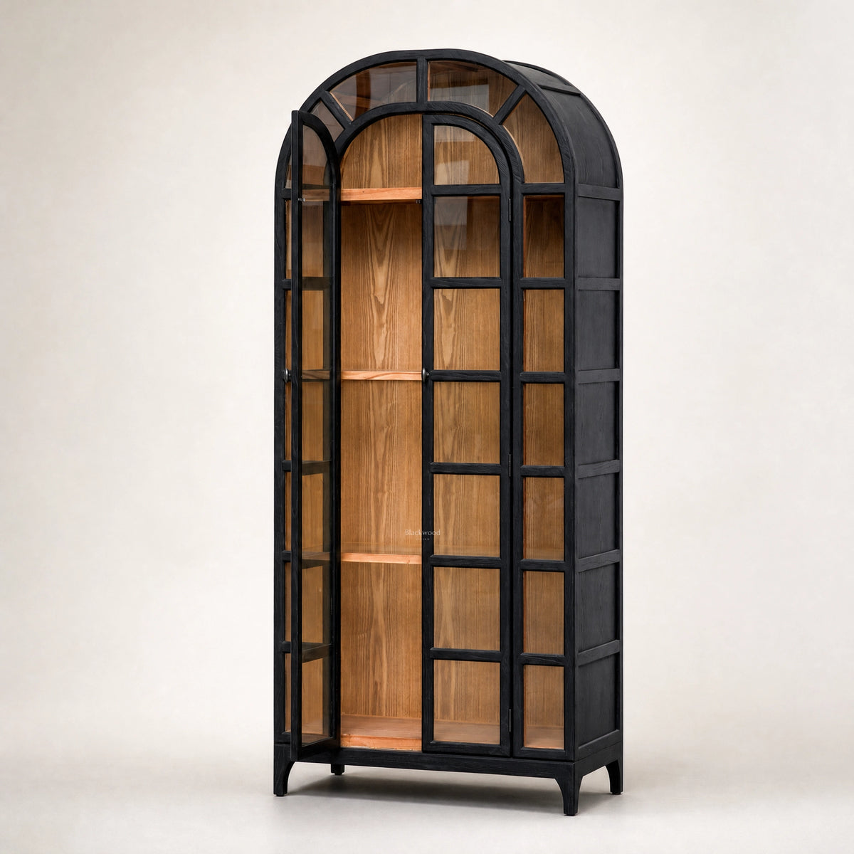 Tall black arched cabinet with glazed doors reveals warm natural elm wood interior and traditional heritage design.