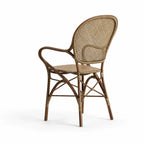 Sika Rossini Rattan Armchair in antique finish, curved frame with woven back and bound joints.