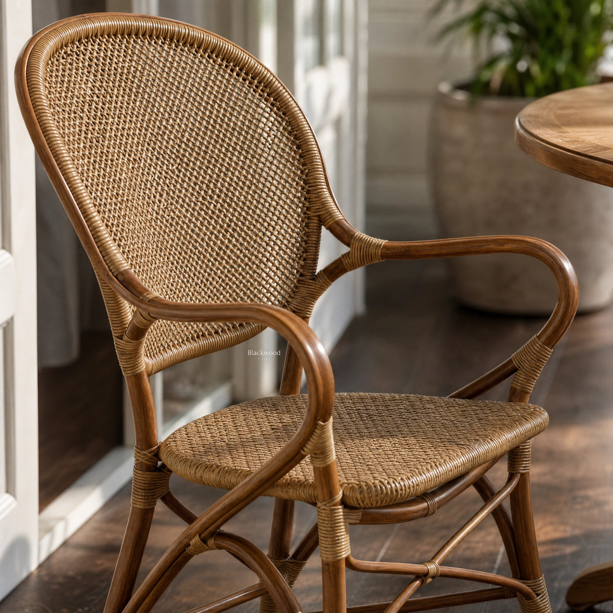Sika® Rossini Rattan Armchair - Antique with curved frame and woven back.