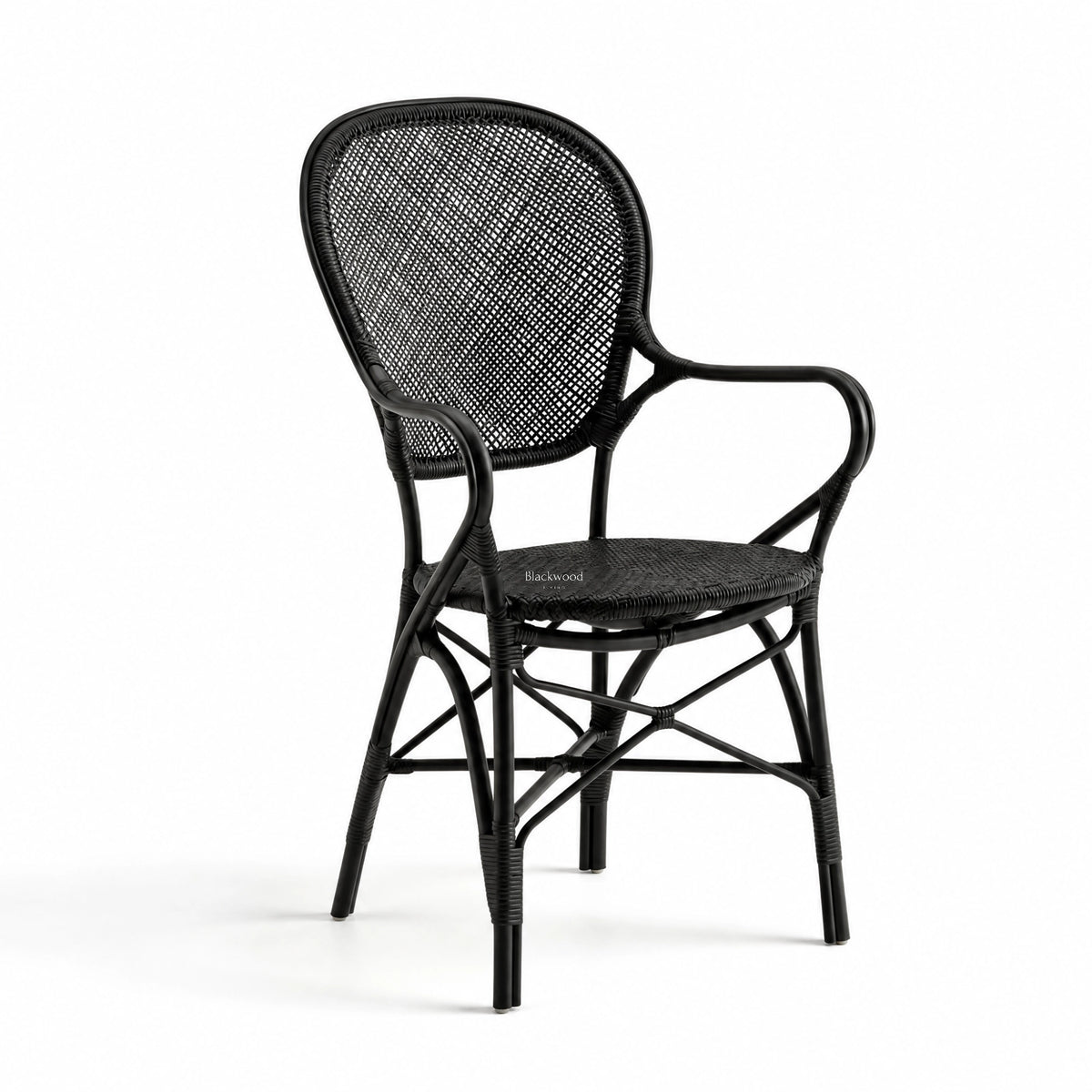 Black Sika Rossini rattan armchair featuring a graceful curved frame, woven back, and finely bound joints for a light visual presence.