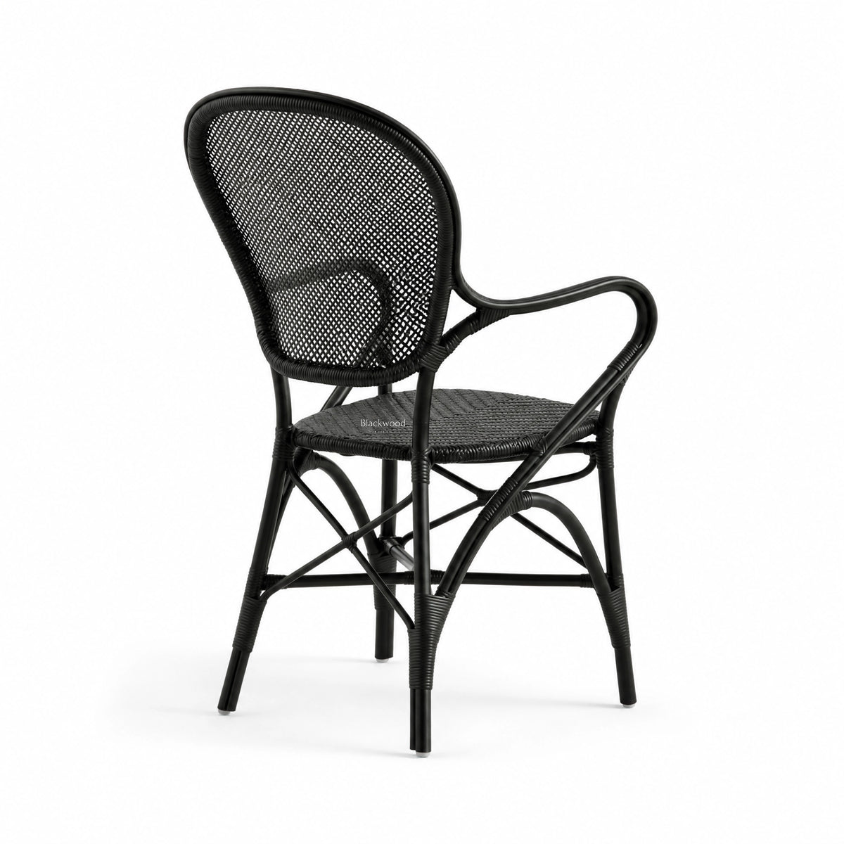 Black Rossini rattan armchair featuring a graceful curved frame, woven back, and finely bound joints.
