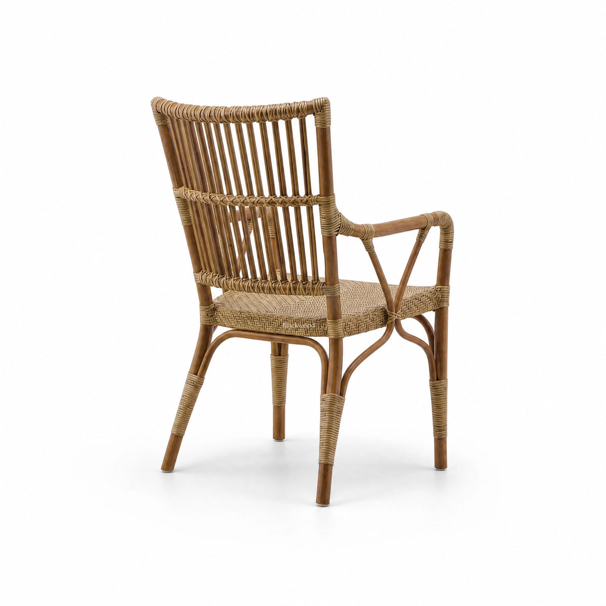Antique rattan armchair with vertical backrest bars, braided seat, and wicker bindings on curved legs and arms.