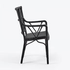 Black handmade rattan armchair with braided seat, structured backrest, and traditional wicker binding.