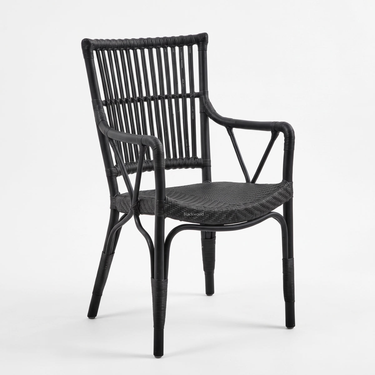 Black handmade rattan armchair featuring a braided seat, structured rattan-bar backrest, and armrests with traditional wicker binding.