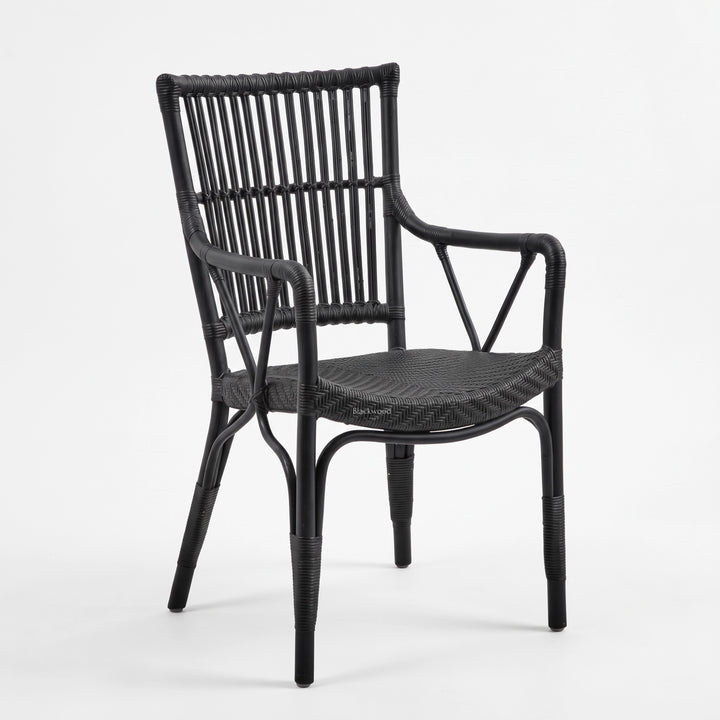 Black handmade rattan armchair featuring a braided seat, structured rattan-bar backrest, and armrests with traditional wicker binding.