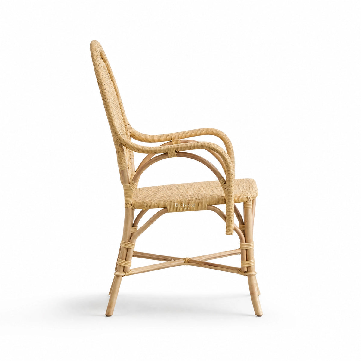 Handcrafted rattan armchair featuring a rounded back, curved arms, and intricate woven panels with detailed bind joints.