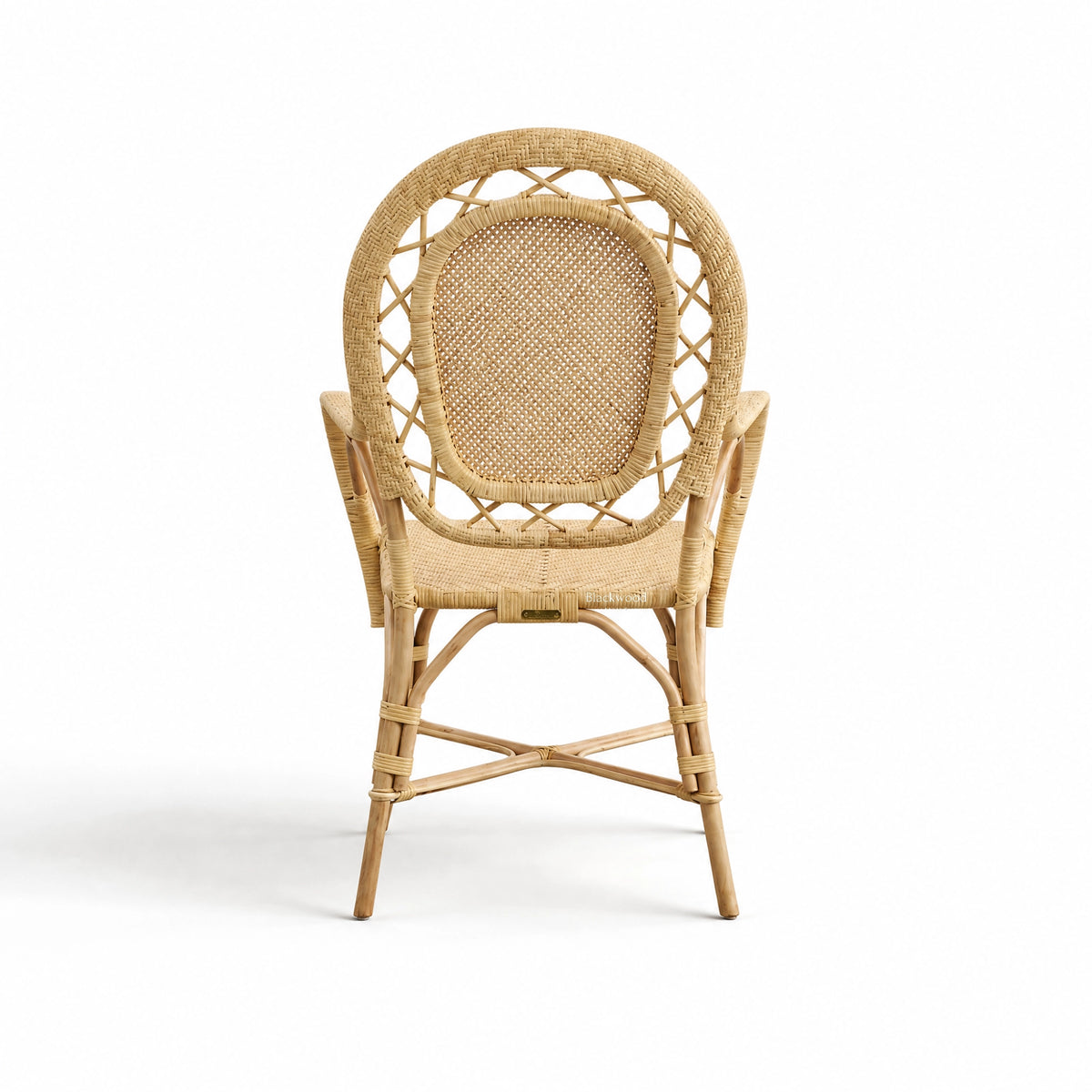 Handcrafted rattan armchair featuring a rounded back, intricate woven panels, and sustainable Indonesian rattan construction.
