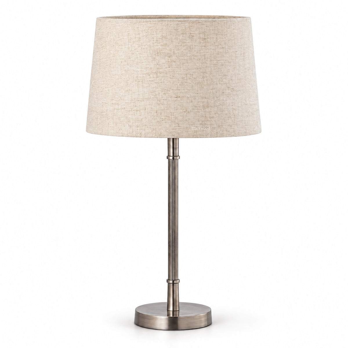 Clarendon table lamp with aged silver fluted metal base and tapered natural linen shade.