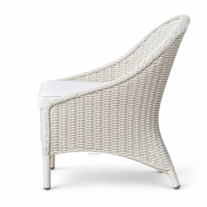 White outdoor rattan chair with sweeping woven profile and crisp white finish, featuring a Mediterranean character and aluminum base.