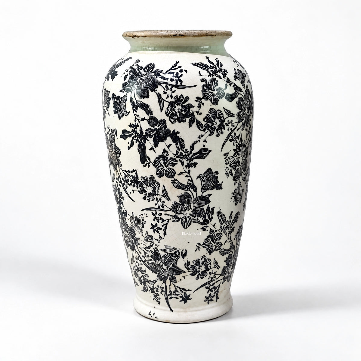 Tall ceramic vase with intricate black botanical pattern on warm ivory ground and muted green rim, featuring a crackled antique finish.