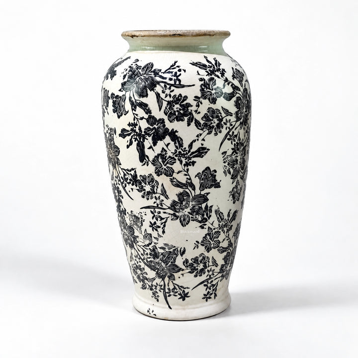 Tall ceramic vase with intricate black botanical pattern on warm ivory ground and muted green rim, featuring a crackled antique finish.