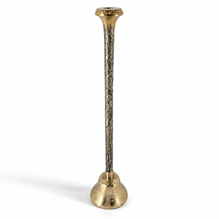 Tall slender aluminium candle holder with textured antique finish and sculptural silhouette featuring tonal variation.