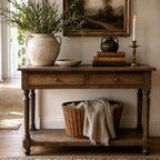Bordeaux Hall Table in oak with natural grain, greenery vase, vintage pot, books, candle, landscape art, and basket.