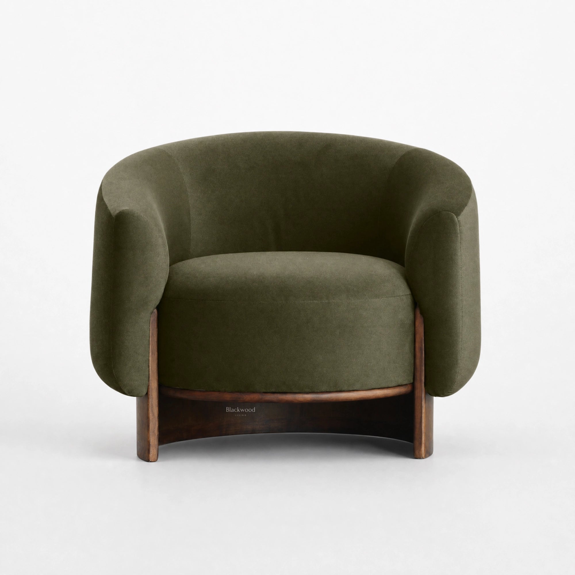 Fairfield Occasional Chair in moss mohair velvet with a curved silhouette and exposed timber legs.