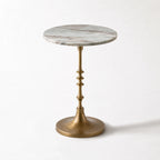 Marcel Side Table with a veined marble top and antique gold pedestal.