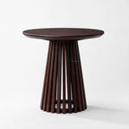 Banyan Side Table with a round cacao-stained solid oak top and a slatted pedestal.