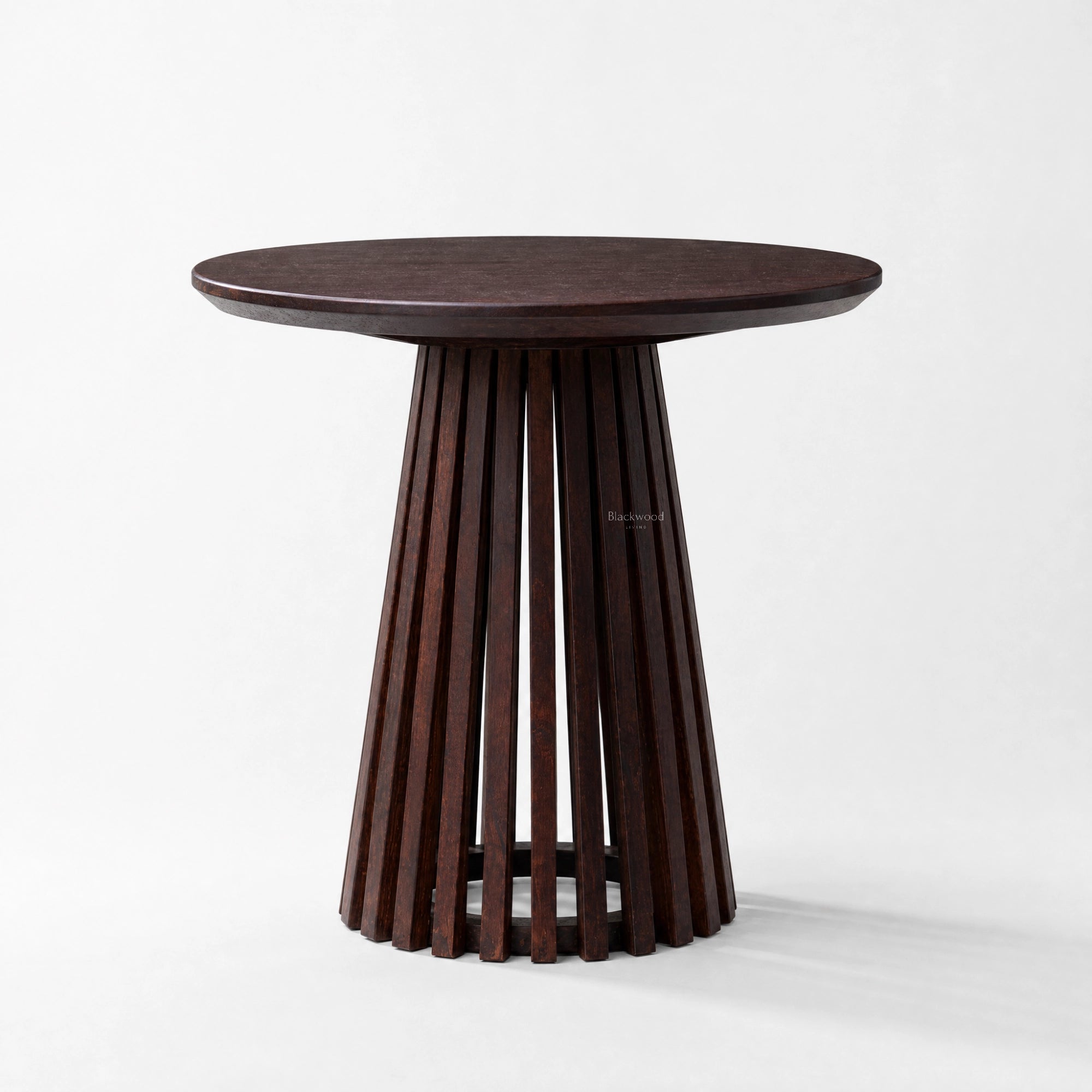 Banyan Side Table with a round cacao-stained solid oak top and a slatted pedestal.