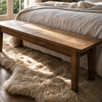 Renwick Bench Seat 170cm in solid mango wood with warm natural grain, set beside a bed in a cozy bedroom.