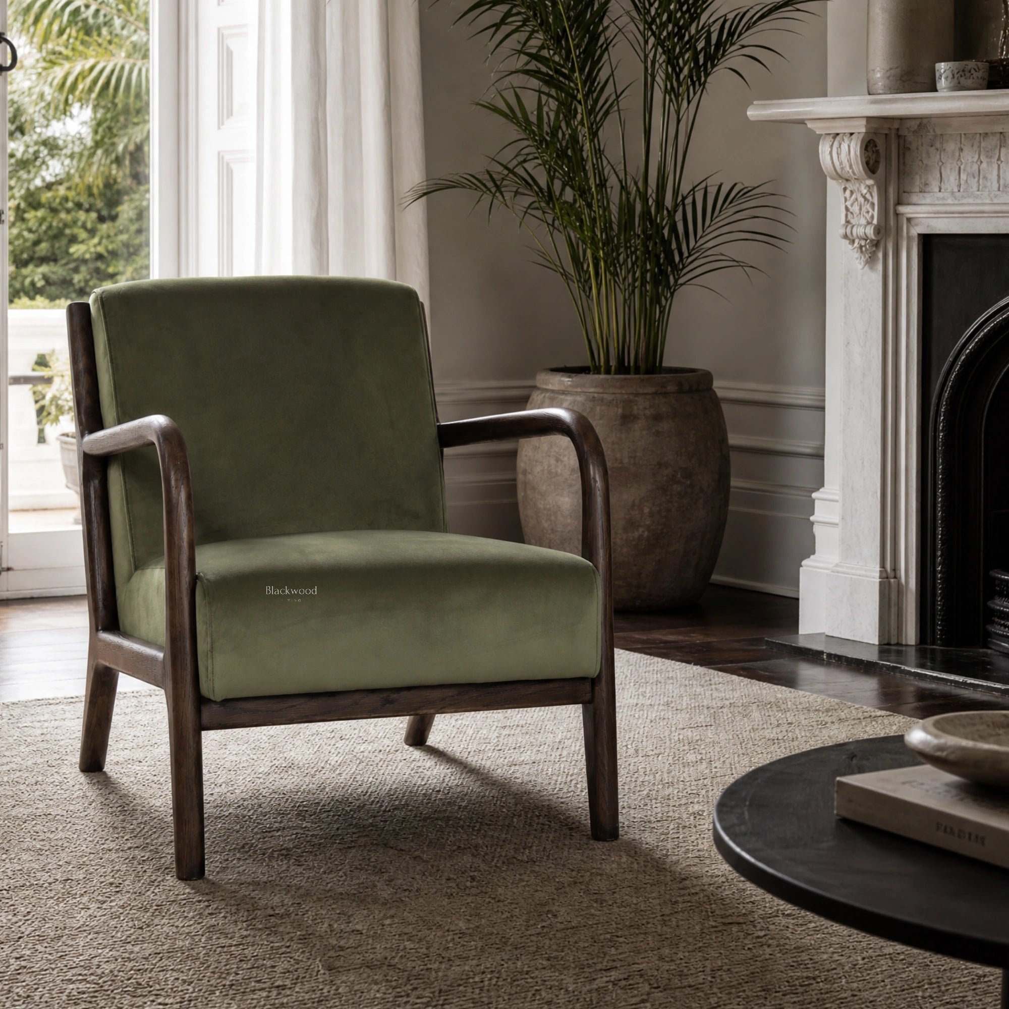Java Occasional Chair with dark oak frame and Rainforest green velvet upholstery in a refined living room.