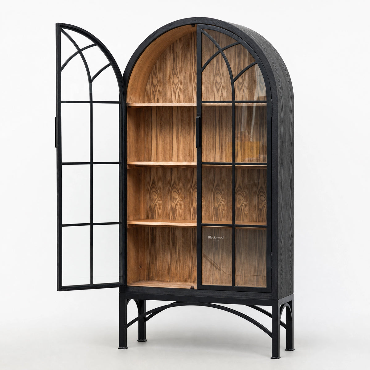 Tall arched display cabinet with black metal frame, glazed doors, and warm wood interior shelves on a metal base.