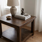 Marlborough Lamp Table in solid mango wood with a lamp, abstract sculpture, and Kinfolk books by a sunlit window.