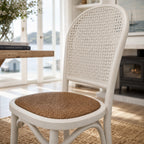 Whitehaven Dining Chair with a white finish and woven cane back and seat, coastal handcrafted style.