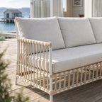 SIKA Exterior Caroline Sofa with cream cushions on handwoven Polystrand fibres rattan frame, outdoor NZ setting.