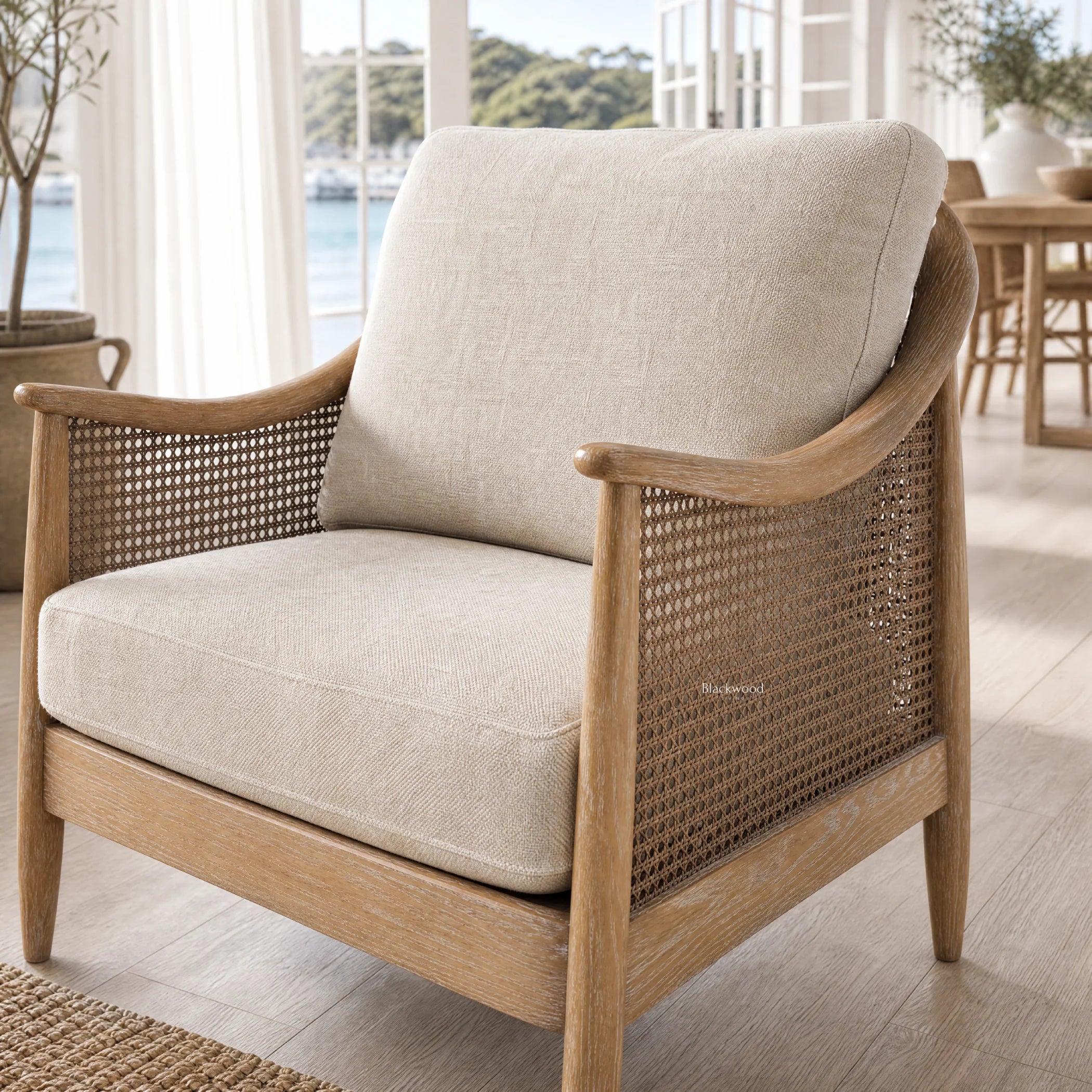 Devonport Chair in solid ash with a whitewashed finish, coastal rattan detailing and plush upholstered cushions.