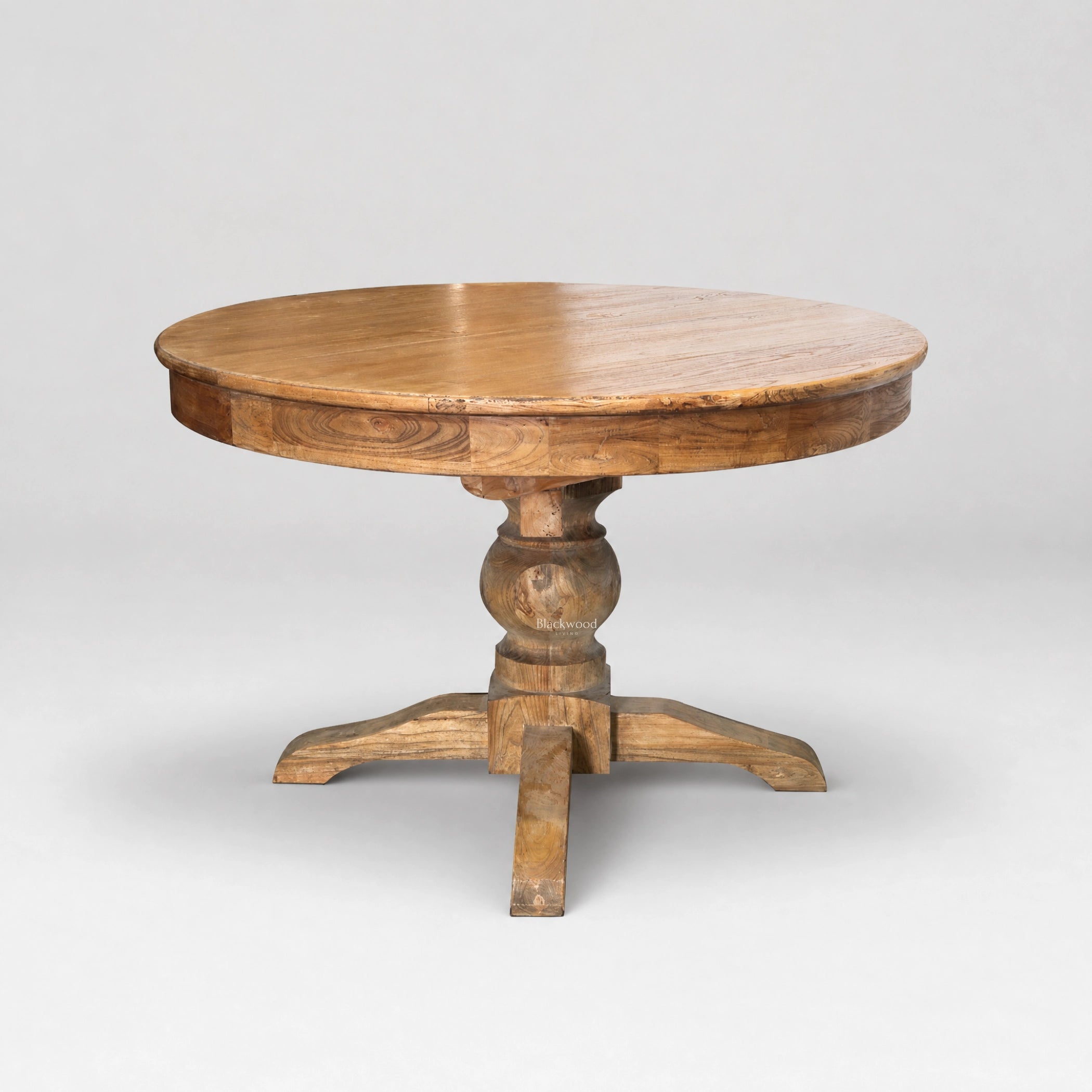 Woodland Extendable Dining Table: round reclaimed elm top with natural grain variation and carved pedestal base.