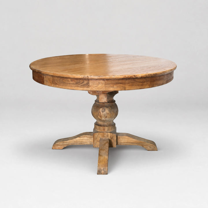 Woodland Extendable Dining Table: round reclaimed elm top with natural grain variation and carved pedestal base.