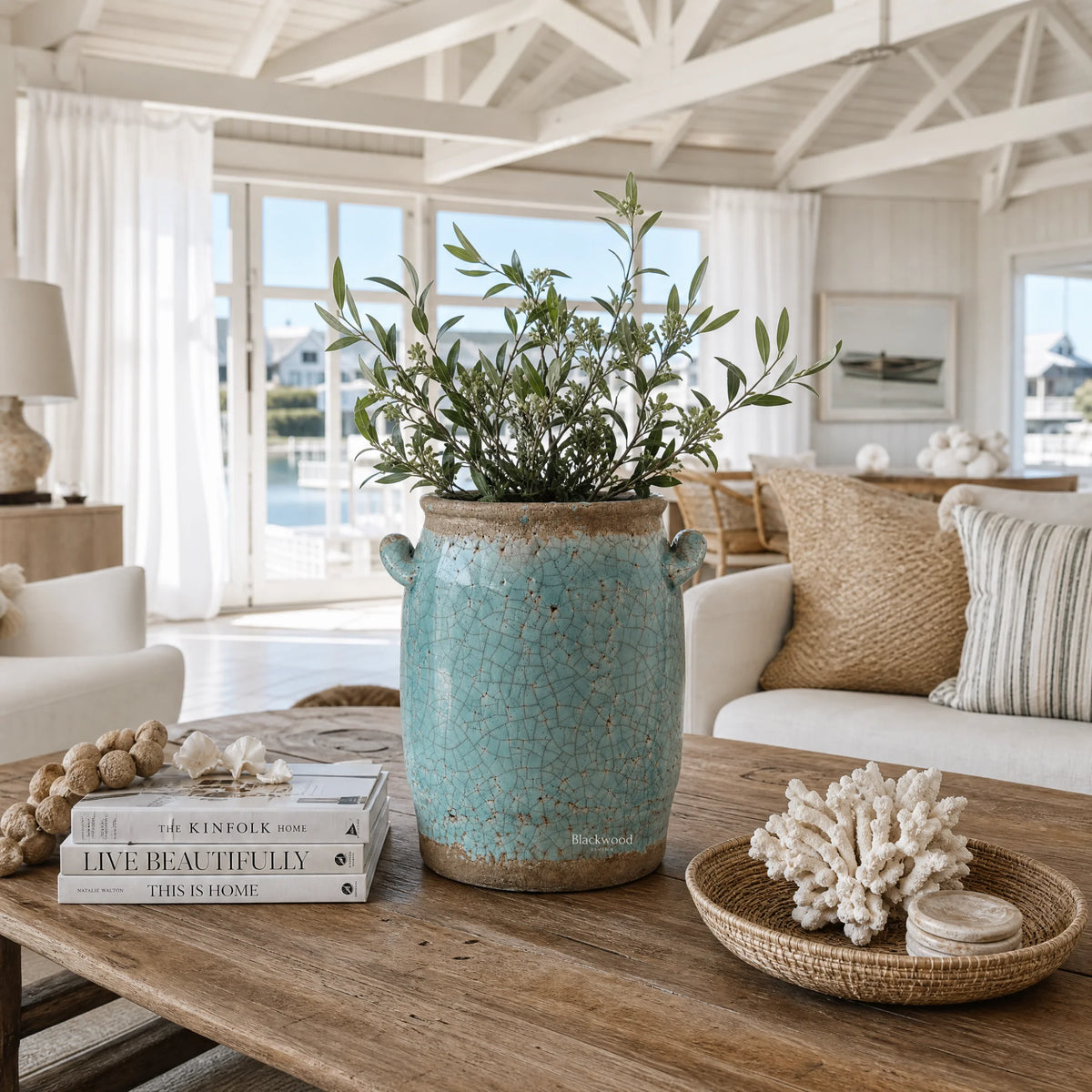 Shoreline Vase 20cm ceramic with crackled coastal blue glaze, greenery, in a sunlit farmhouse-lodge living room.