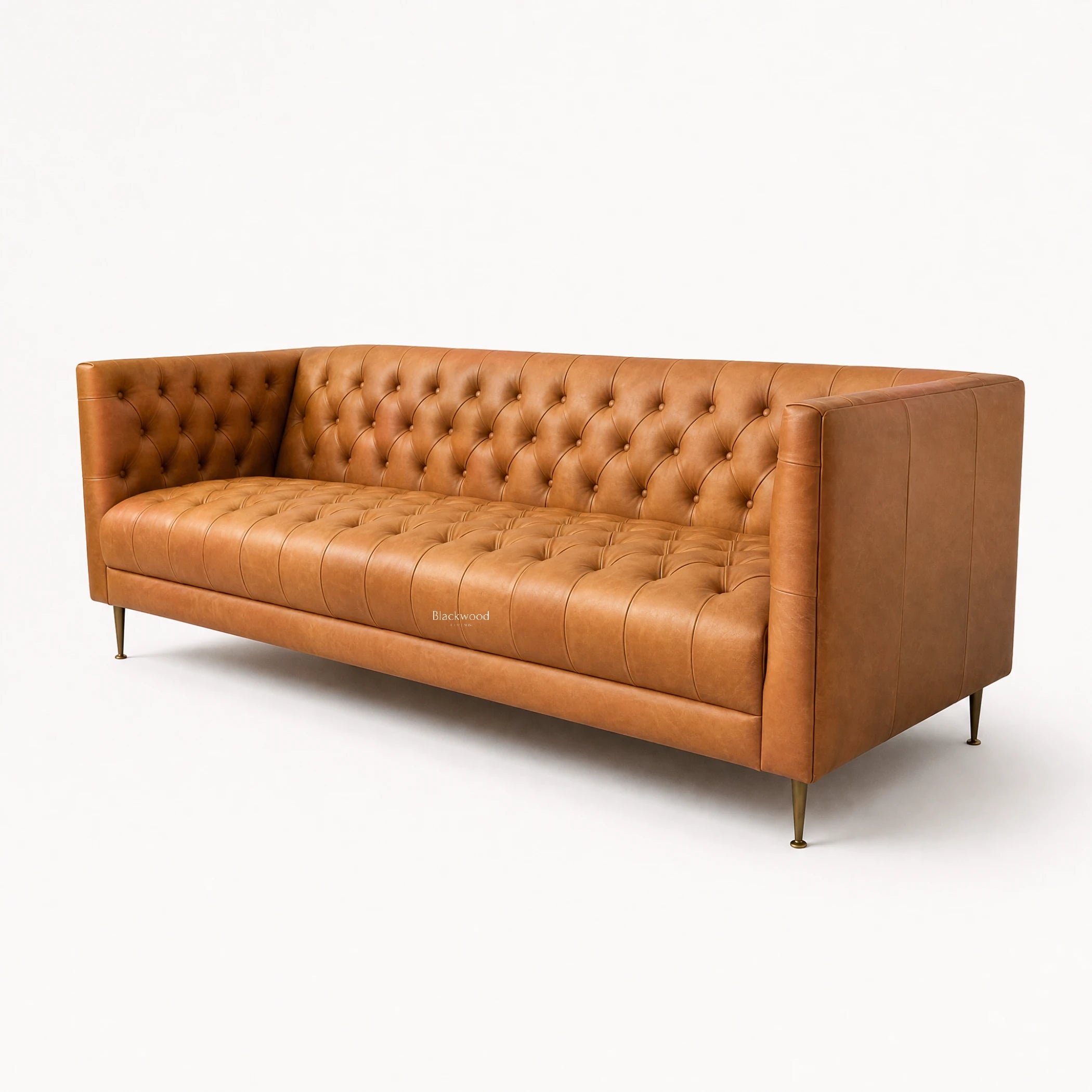 Wellington Club Sofa in rich tan leather with button-tufted upholstery and brass legs.