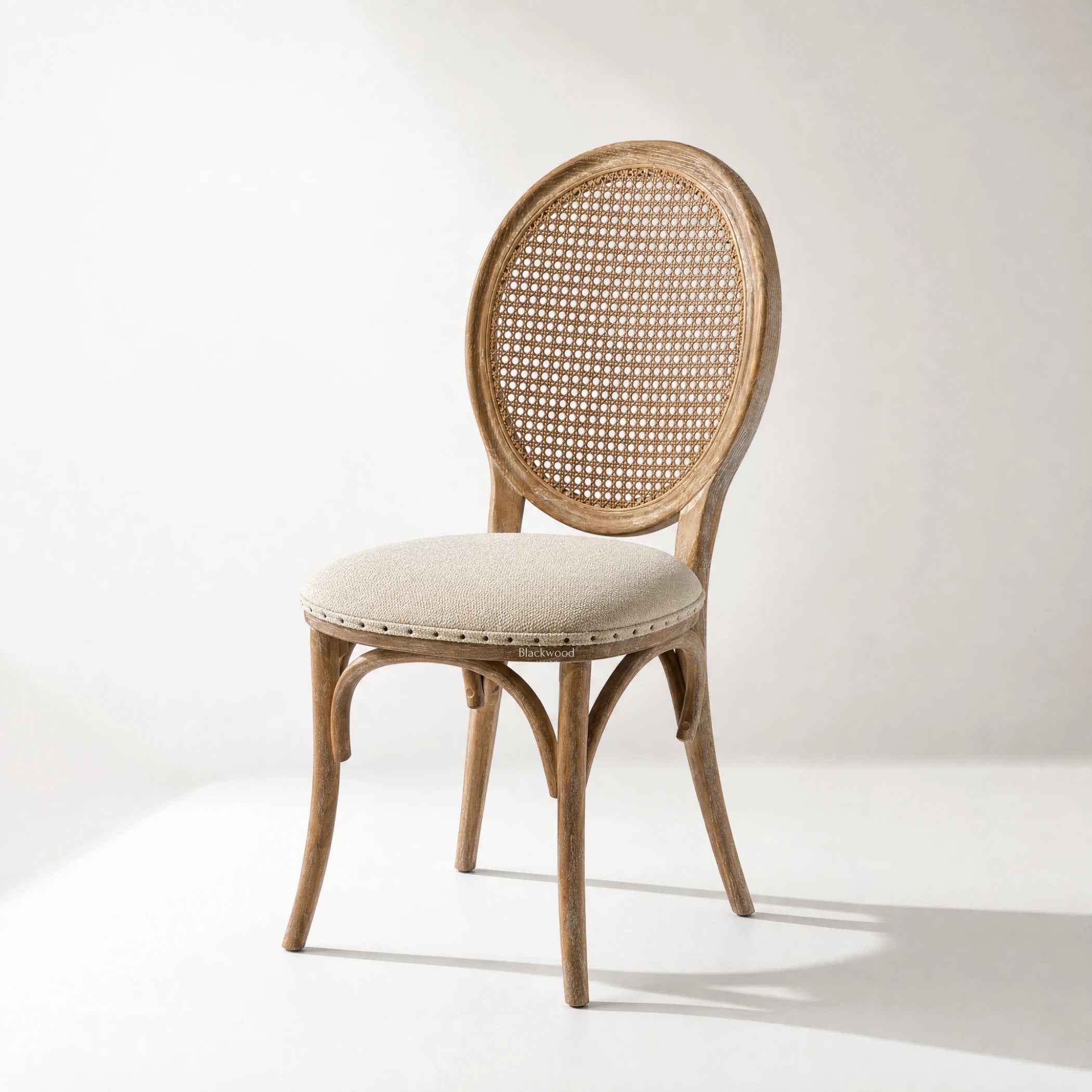 Camille Dining Chair: burnt oak frame with handwoven rattan caned back and linen upholstered seat