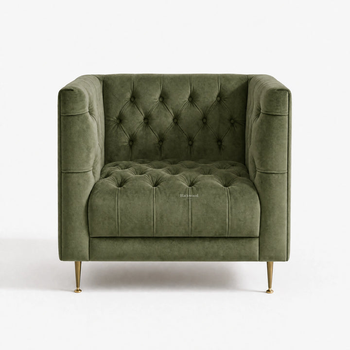 Wellington Club Chair in green velvet with deep button tufting and curved arms, brass legs.