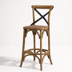 Provence Counter Stool in aged oak with a woven cane seat and black metal X-back supports.