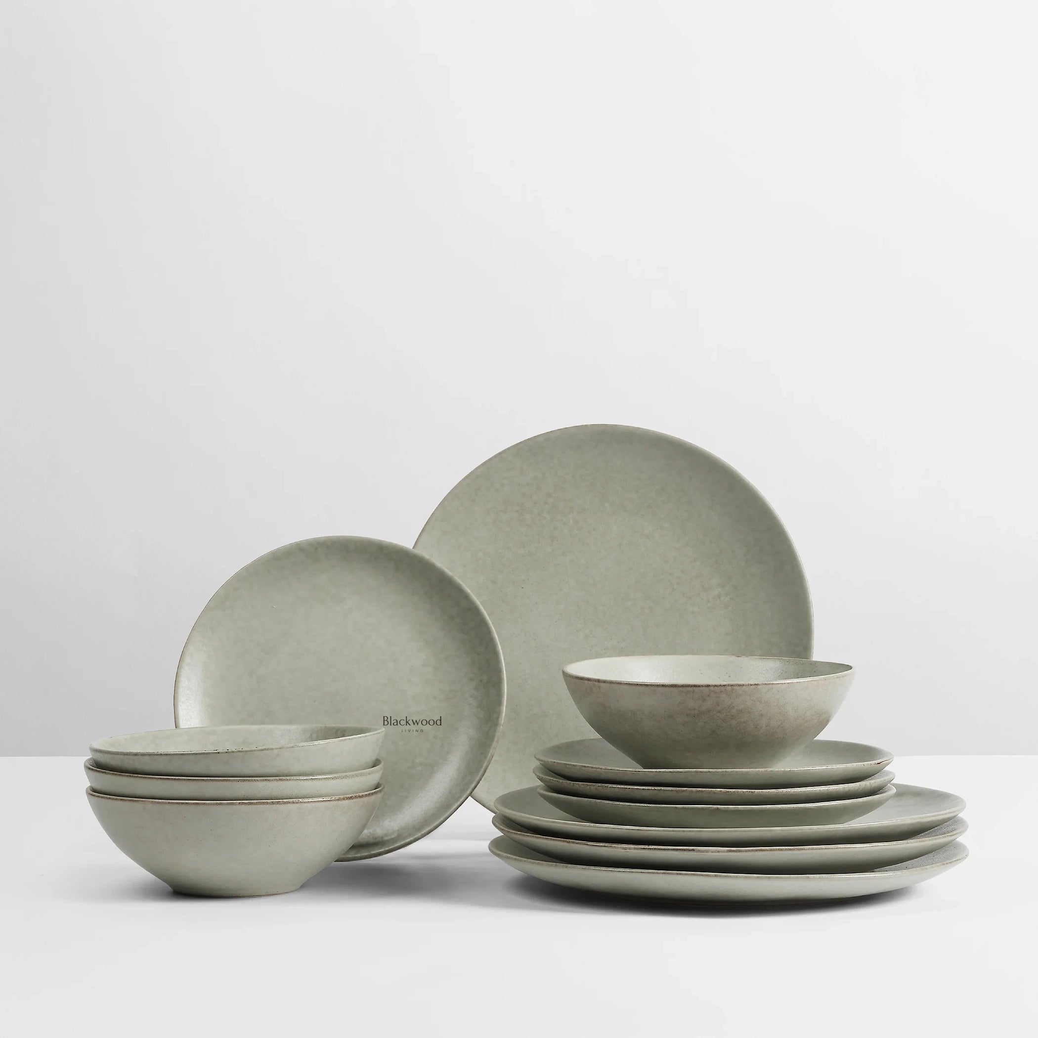 BROSTE Dinner Set for 4 from Nordic Marsh collection in green-gray ceramic, stacked bowls and plates.