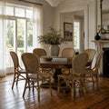 Sika Rossini Rattan Side Chairs around a round wooden dining table in a bright, classic room with woven cane seats.