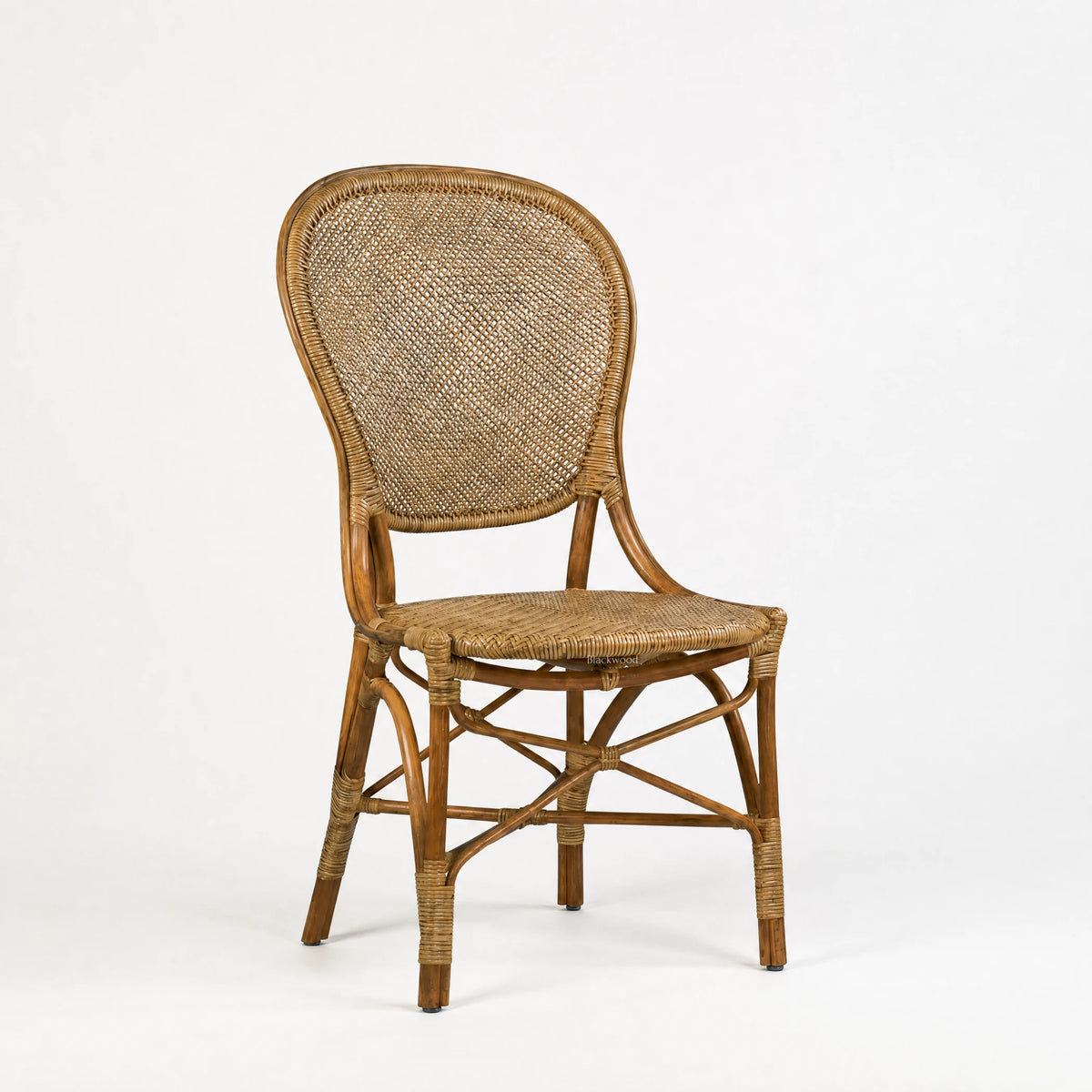 Sika Rossini Rattan Side Chair with curved rattan frame and woven cane back and seat in natural brown.