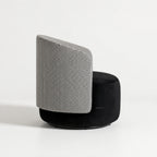 Estella Swivel Chair with houndstooth upholstery, curved silhouette and plush black seat on a round base.