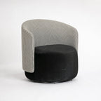 Estella Swivel Chair with houndstooth upholstery on a curved back and black plush seat.