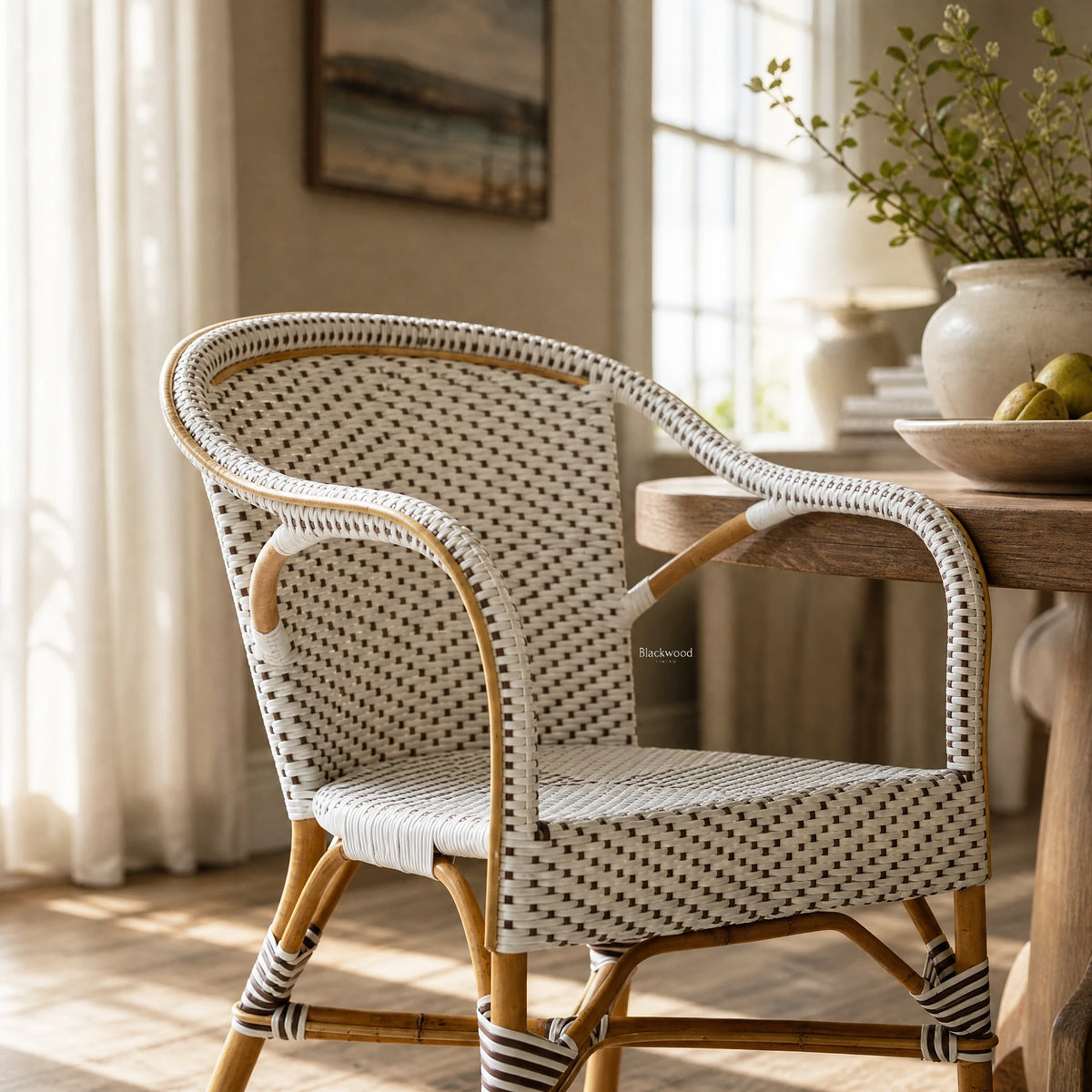 Sika® Affair Madeleine Rattan Armchair with natural frame and woven ArtFibre in a sunlit coastal space.