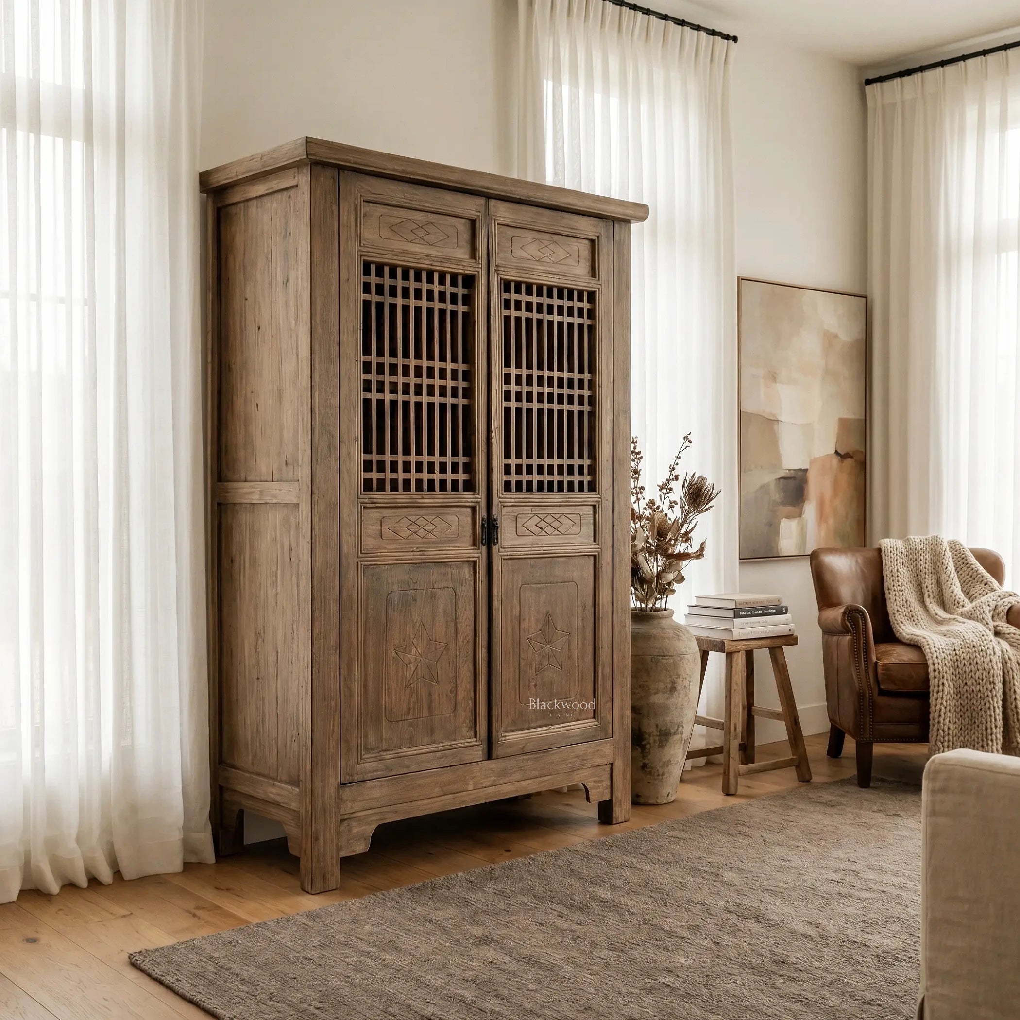 Eastwind Cabinet in weathered reclaimed elm with lattice doors in a bright living room.