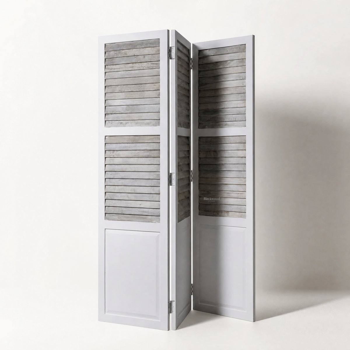 Whitehaven Room Divider in distressed antique white mango wood with hinged louvered panels.
